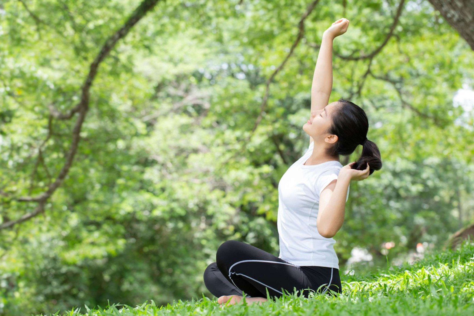 Young woman stretching oneself in the nature park .health concepts.